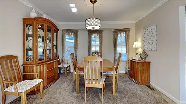 a dining room with furniture a chandelier and window