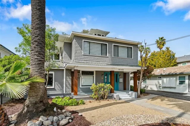 a front view of a house with a yard and outdoor seating
