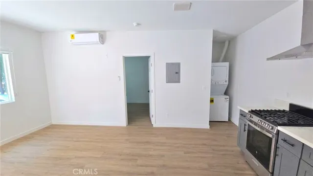 a kitchen with a refrigerator and a stove top oven