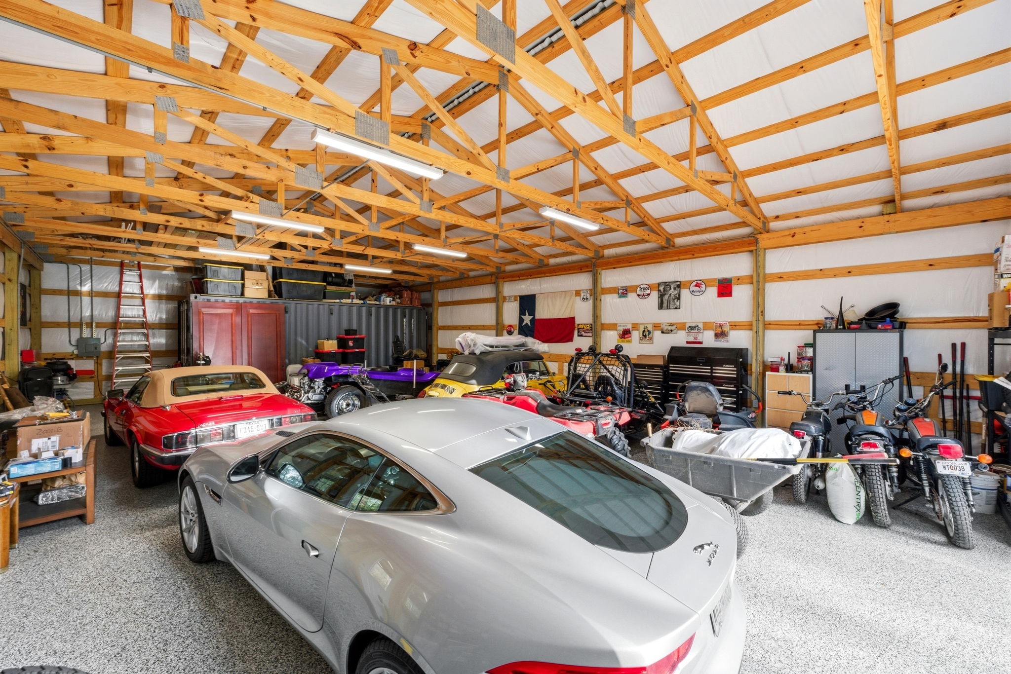 280 Sundog Road Huntsville, TX 77340 - Photo 49 of 50 Spacious interior with epoxy flooring offers endless possibilities—perfect for classic cars, a workshop, hobby space, equipment storage, or additional project area.
