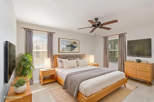 a bedroom with a bed and a flat screen television