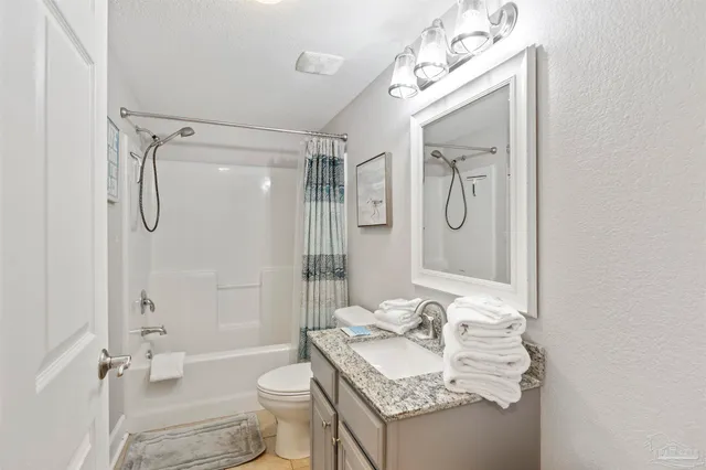 a kitchen with granite countertop a sink and cabinets
