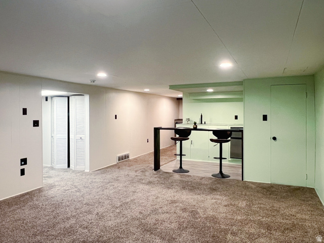 3138 Jean Street Magna, UT 84044 - Photo 20 of 26 Finished lower level featuring a built-in wet bar with a sink and under-counter refrigerator