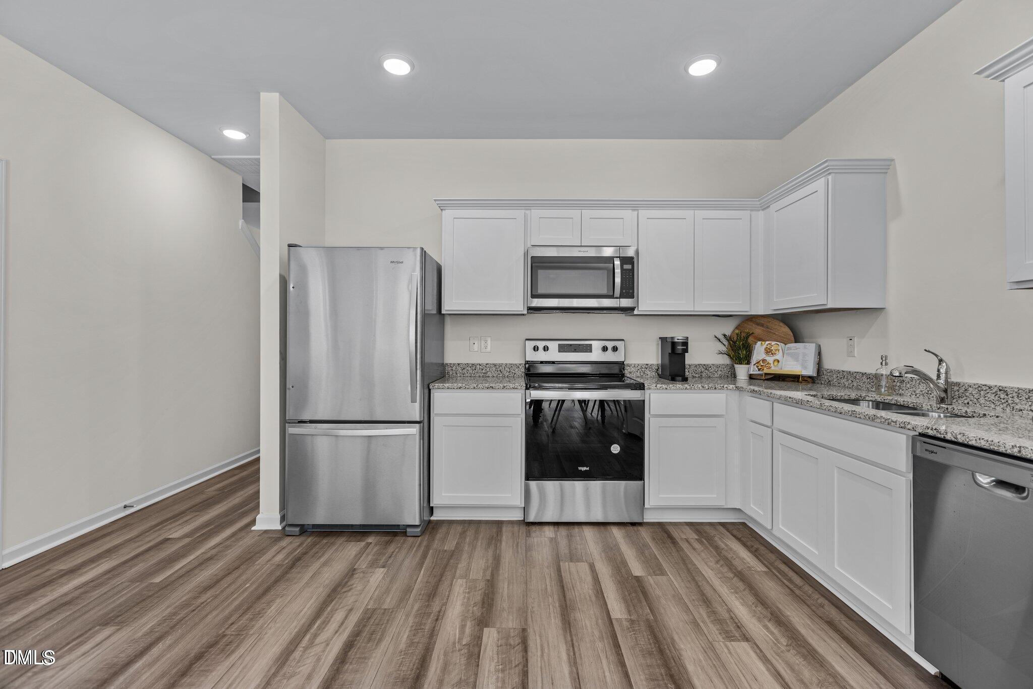 152 North Chubb Ridge Wilson's Mills, NC 27520 - Photo 14 of 22 a kitchen with granite countertop a refrigerator stove and sink
