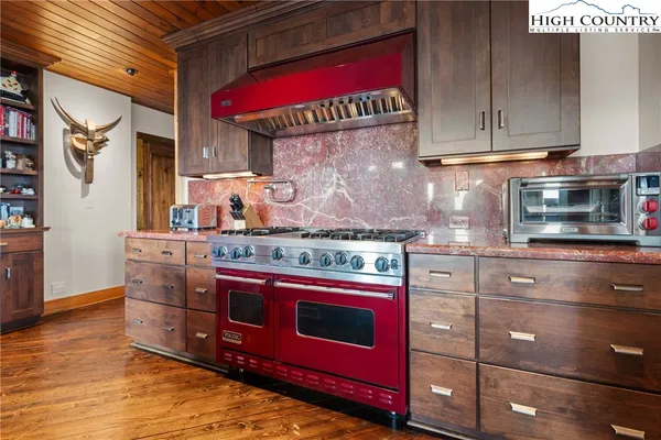 a kitchen with stainless steel appliances granite countertop a stove and a microwave