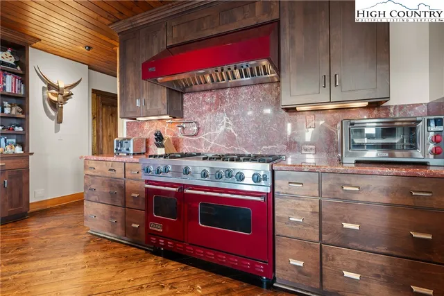 a kitchen with stainless steel appliances granite countertop a stove and a microwave