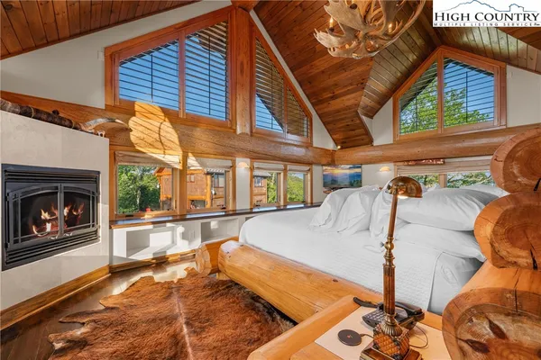 a view of a patio with a table and chairs under an umbrella with a fireplace