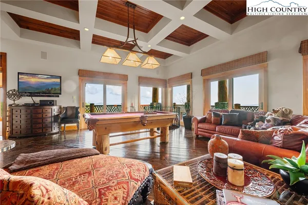 a living room with furniture a fireplace and a table