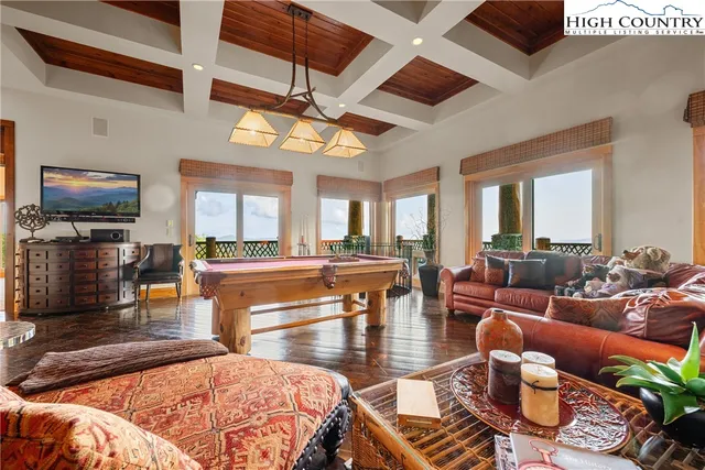 a living room with furniture a fireplace and a table