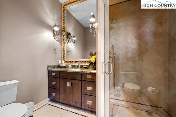 a spacious bedroom with a bed and a chandelier