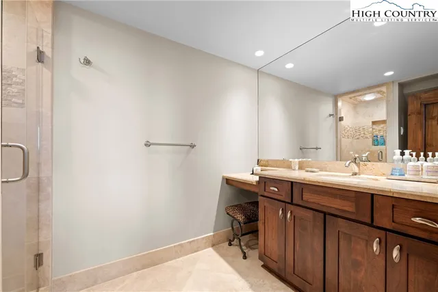 a spacious bedroom with a bed and a flat screen tv