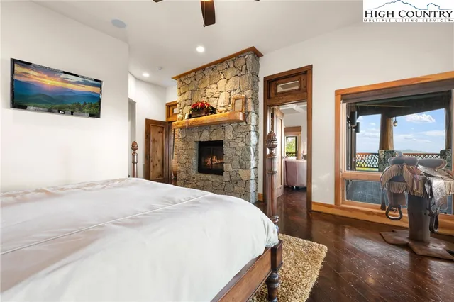 a bed sitting in a spacious bedroom next to a window