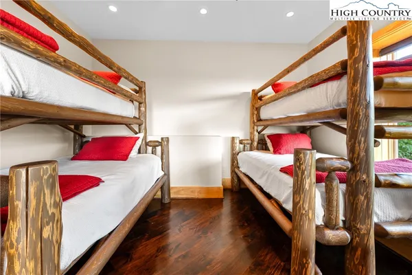 a bathroom with a granite countertop sink a toilet a mirror and shower