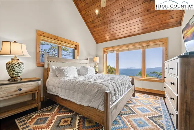 a bathroom with a granite countertop double vanity sink a mirror and a window