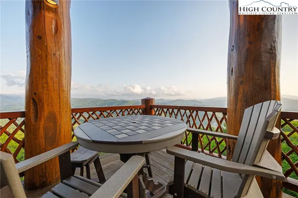 a view of balcony with wooden floor and outdoor seating