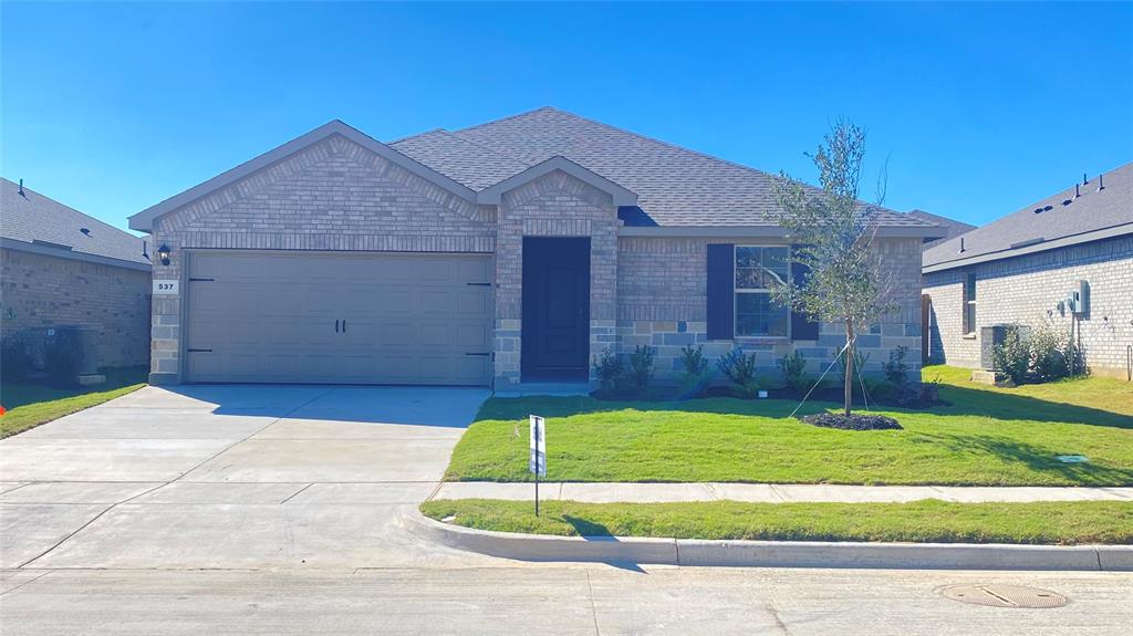 537 Marsh Street Cleburne, TX 76033 - Photo 1 of 1 a house that has a big yard with plants
