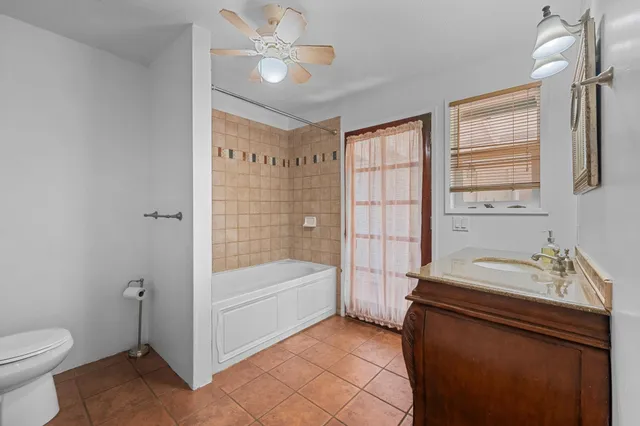 a bathroom with a sink a toilet and bathtub