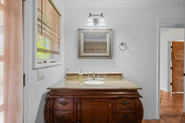 a view of utility room that has a sink and a window