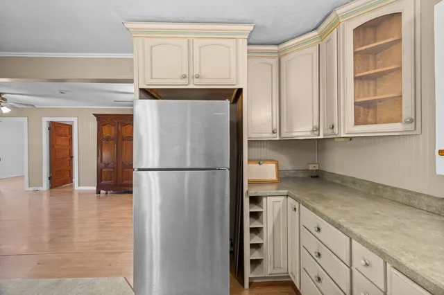 a kitchen with stainless steel appliances granite countertop a refrigerator and cabinets