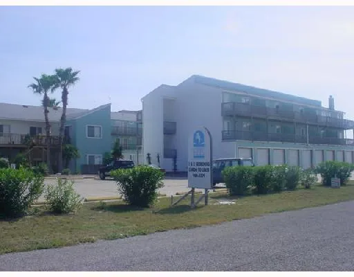 a brick building with a yard in front of it