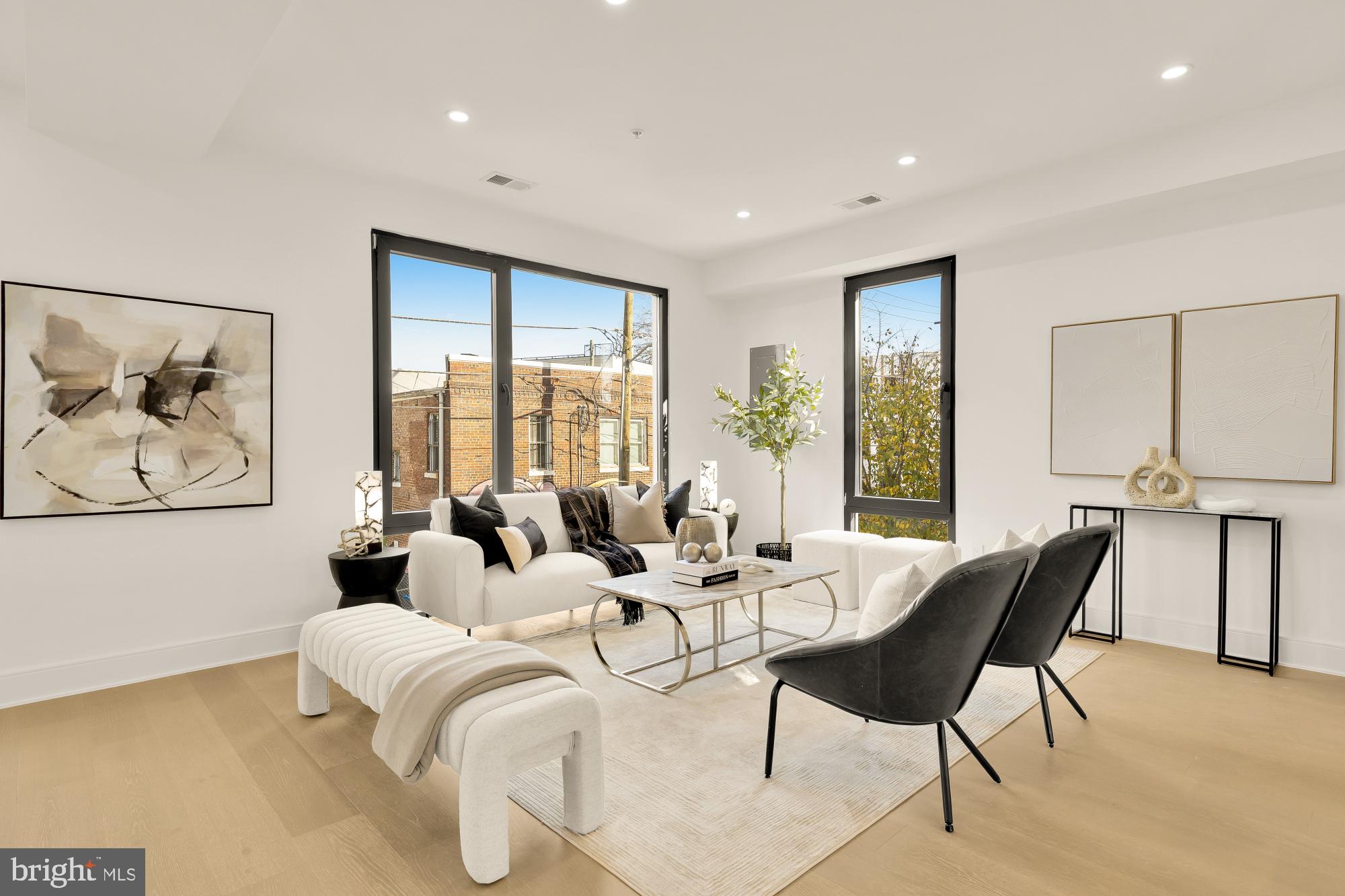 a living room with furniture and large windows