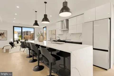 a kitchen with a table chairs sink and white appliances
