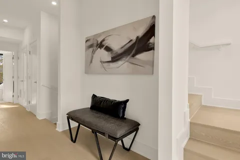 a bedroom with a bed and large windows