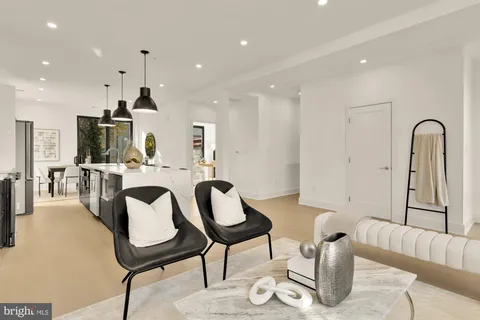 a dining room with furniture and view of kitchen
