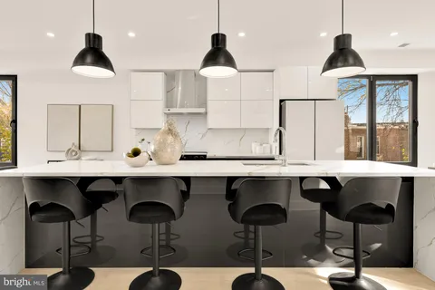 a kitchen with a table and chairs in it