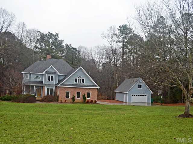 2416 Mt Vernon Church Road Raleigh, NC 27614 - Photo 1 of 11 a front of a house with a yard and large trees
