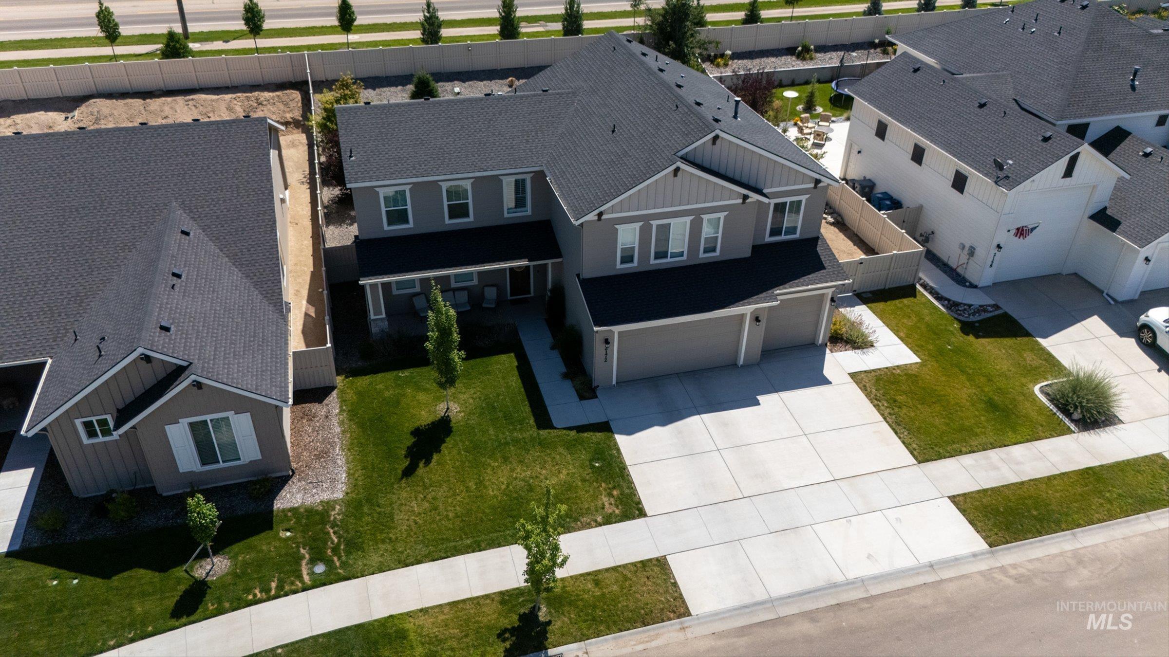 2172 Savoy Court Middleton, ID 83644 - Photo 38 of 46 Contemporary two-story residence featuring a dark shingle roof, light gray siding, and a two-car garage