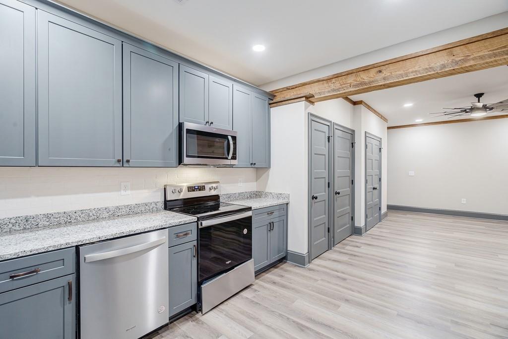 34 Depot Street, Unit 24 Hartwell, GA 30643 - Photo 11 of 22 a kitchen with stainless steel appliances granite countertop a stove a sink and a refrigerator
