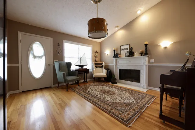 a living room with furniture and a fireplace