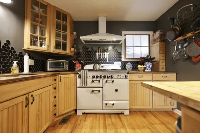 a kitchen with a stove a sink and a refrigerator