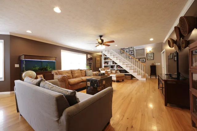 a living room with furniture and a wooden floor