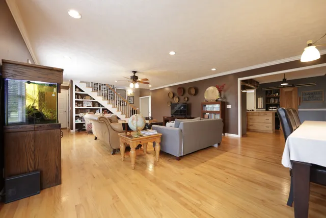 a living room with furniture dining table and a wooden floor