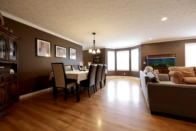 a view of a dining room with furniture window and wooden floor