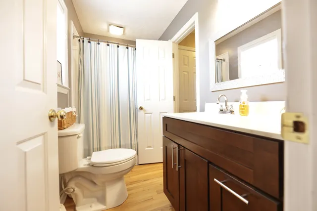 a spacious bedroom with a bed and a chandelier