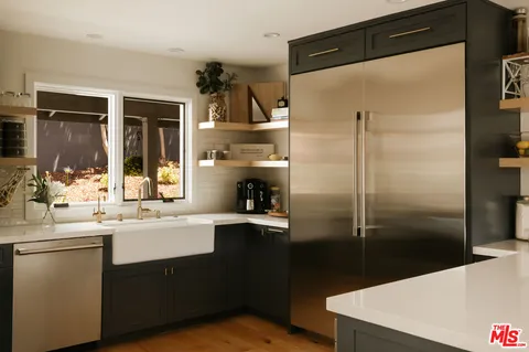 a kitchen with a sink and refrigerator