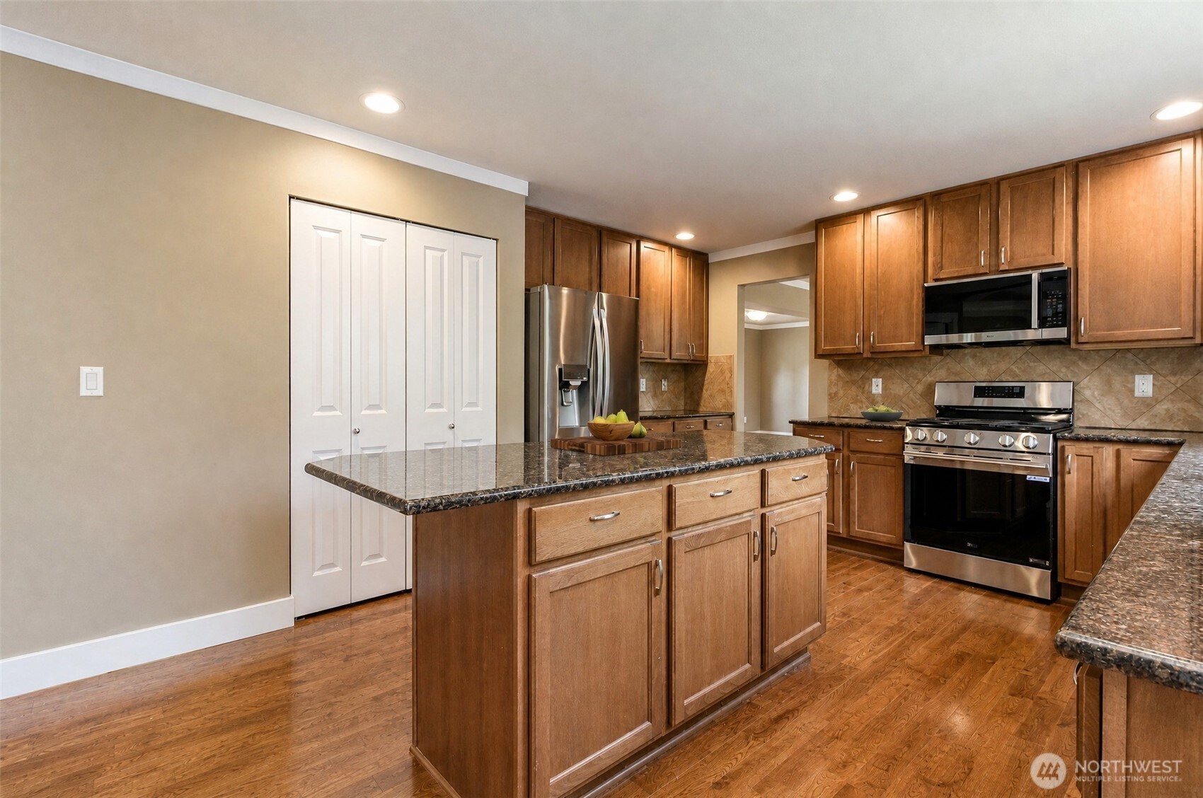 3000 South Mt Baker Boulevard Seattle, WA 98144 - Photo 15 of 40 a kitchen with stainless steel appliances granite countertop a stove top oven a sink dishwasher a refrigerator and a microwave oven with wooden floor
