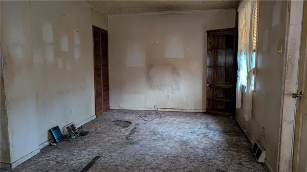 a view of a room with a table and chairs