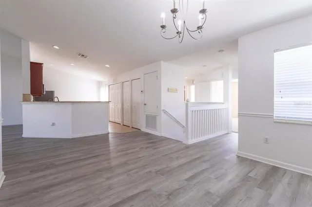 a view of a kitchen with a microwave and wooden floor