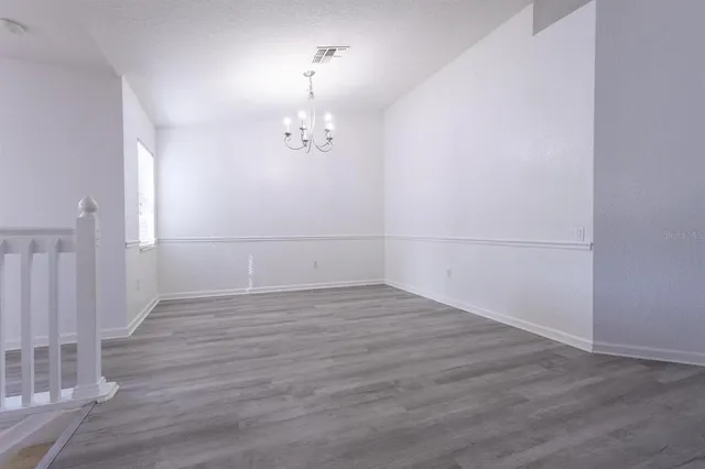 an empty room with wooden floor