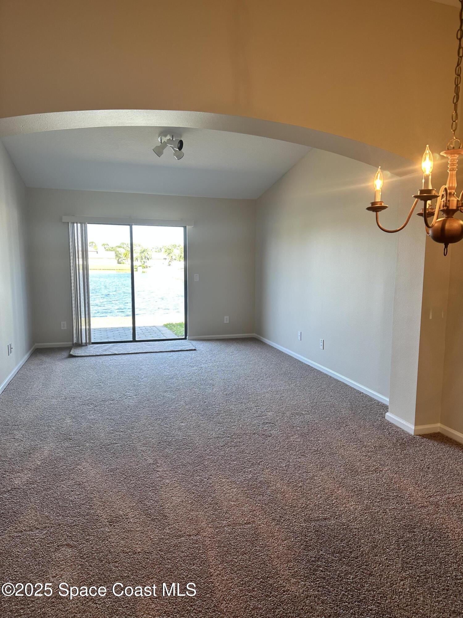 975 Luminary Circle, Unit 103 Melbourne, FL 32901 - Photo 5 of 11 a view of an empty room with a window
