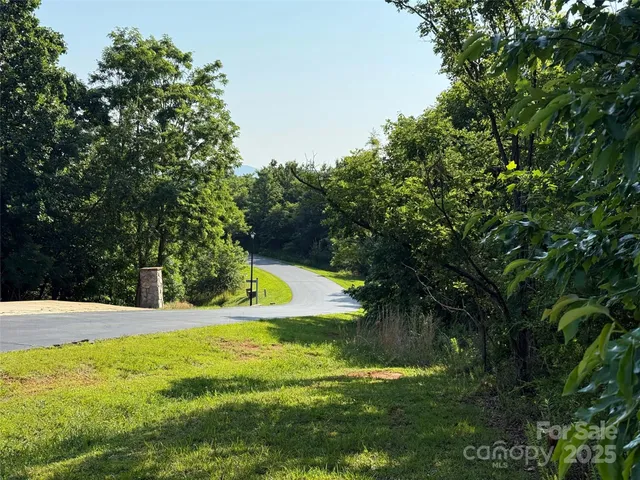 a view of a house with yard and sitting area