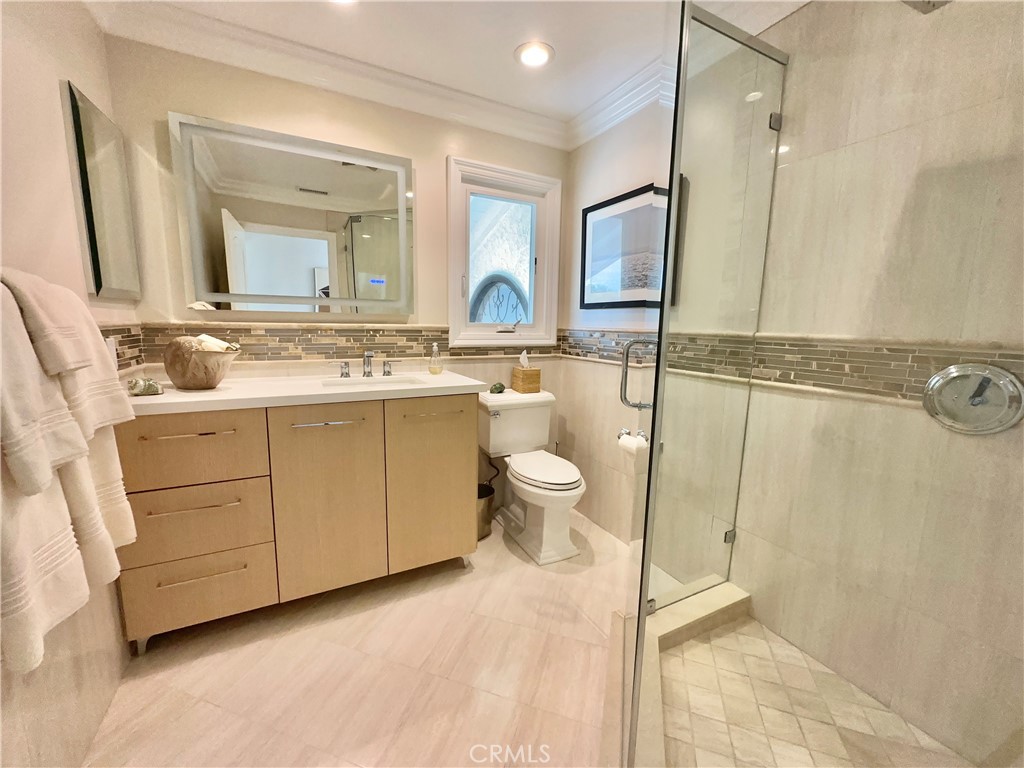 15 Curl Drive Corona del Mar, CA 92625 - Photo 19 of 26 a bathroom with a double vanity sink mirror and toilet
