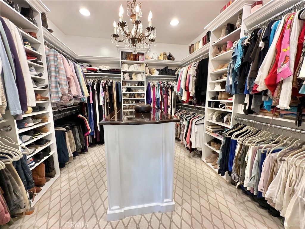 15 Curl Drive Corona del Mar, CA 92625 - Photo 8 of 26 a view of a walk in closet with clothes and shoes