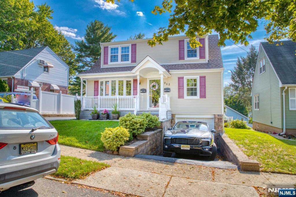 202 Stone Street Maywood, NJ 07607 - Photo 2 of 11 a front view of a house with a garden and yard