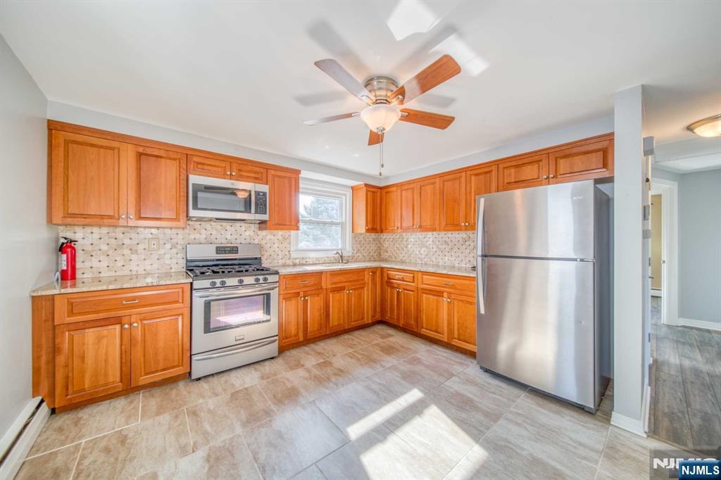 202 Stone Street Maywood, NJ 07607 - Photo 7 of 11 a kitchen with stainless steel appliances granite countertop a refrigerator and a sink