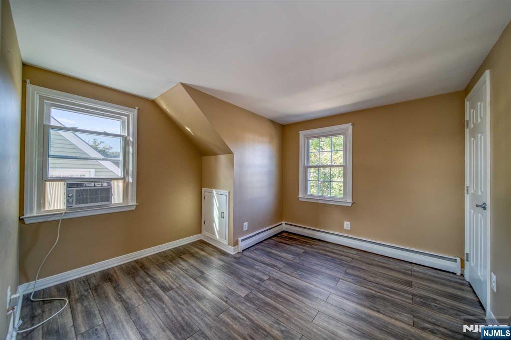 202 Stone Street Maywood, NJ 07607 - Photo 8 of 11 a view of an empty room with wooden floor and a window